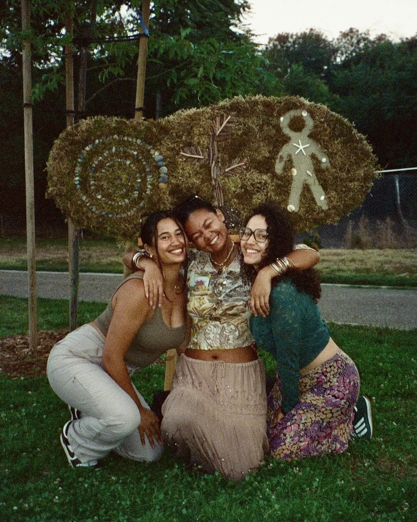 Three friends embracing at a Second Nature Collective gathering